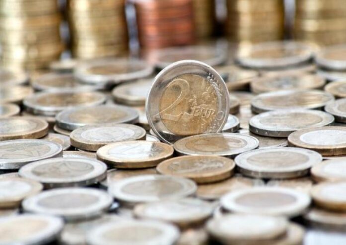 Grungy 2 euro coin with coins on background